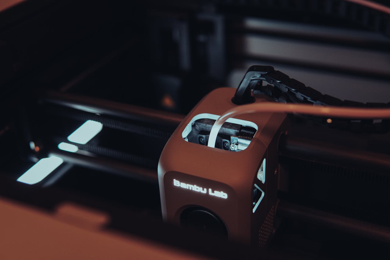 about-us Detailed view of a 3D printer mechanism in a dark setting, highlighting technology.